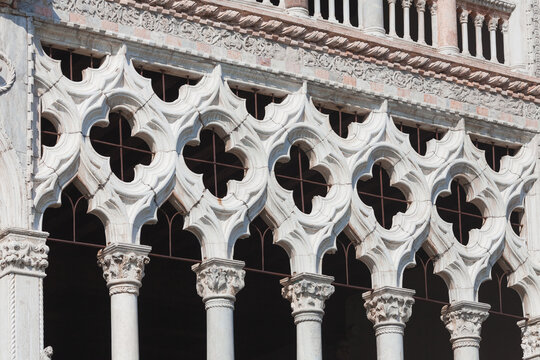 Close up of gothic architecture in Venice with traditional trefoil stone arches and quatrefoil windows. Facade of Ca d Oro Palace on Grand Canal.