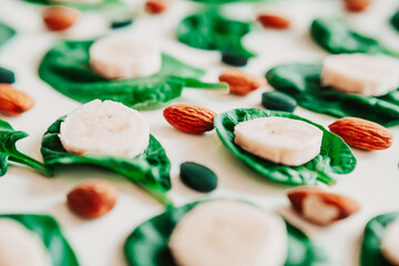 banana, almonds, spinach, vitamins on the table