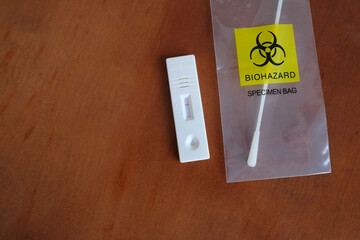 Coronavirus (COVID-19) rapid test with negative result next to a nasal swab in a transparent bag...