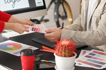 Male designer with colleague working in office