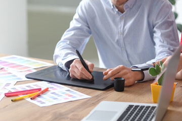 Young male designer working in office