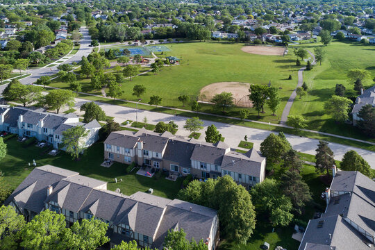 An aerial of a playground, baseball fields and tennis courts in the suburban neighborhood of Palatine, Illinois in summer.
