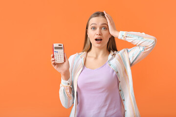 Surprised woman with calculator on color background