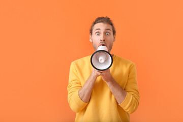 Stressed young man with megaphone on color background