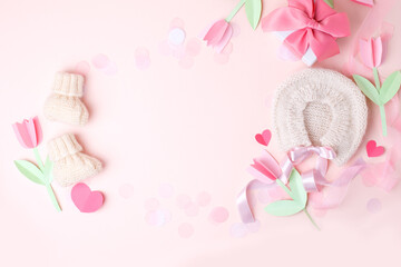 Pink knitted bonnet and booties socks. Set of baby clothes and accessories for spring or summer, mother day. Fashion childs outfit, first baby girl wardrobe, baby shower. Flat lay, top view, copyspace