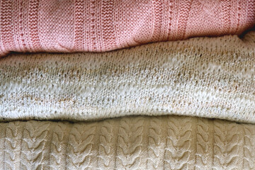 Stack of folded sweaters. Top view.