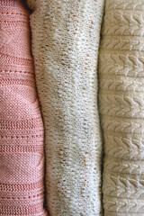 Stack of folded sweaters. Top view.