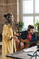 Couple of artists performing together in recording studio