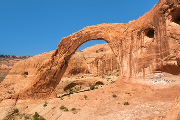 A hiker is dwarfed by Corona Arch in an area near Moab in Utah.