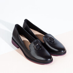 Woman shoes with long shadow on white background