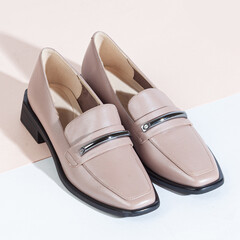 Woman shoes with long shadow on white background