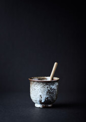 Traditional, handcrafted ceramic on dark background. Soft focus. Copy space.	