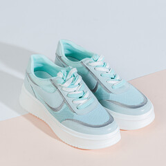 Woman shoes with long shadow on white background