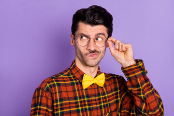 Photo of unsure uncertain young guy wear plaid shirt arm spectacles looking empty space isolated...