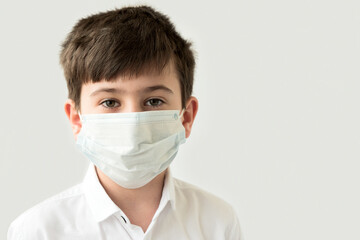 Portrait of caucasian child boy in medical protective face mask