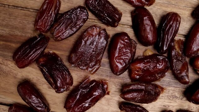 Dried dates on a wooden board - studio photography