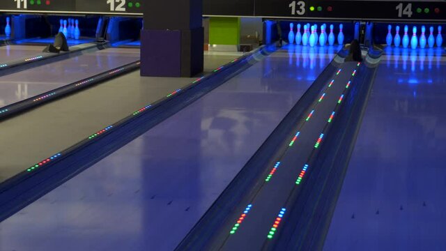 A bowling ball traveling down the lane and does not hit pins.