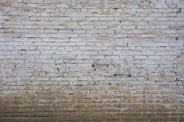 An old, ragged white brick wall.