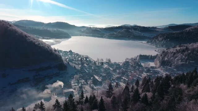 Aerial Shot of Popular Destination in Slovakia during Winter - Dedinky in Slovak Paradise. Frozen Lake and Majestic Fog.