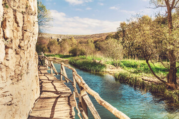 Fototapeta na wymiar Wooden Bridge above Zlatna Panega River in the Summer .Geopark Iskar Panega Eco Path in Bulgaria