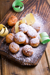 Baked castagnole with powdered sugar and confetti. Street food, round biscuits with sugar for the carnival of Venice. Traditional sweet pastries during the carnival period in italy. copy space