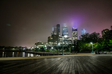 New York City downtown skyline in rainy foggy night, long exposure shot with wide angle perspective