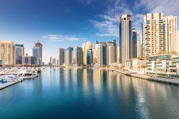 Fototapeta na wymiar Panoramic citiscape view of the neighborhood of the Dubai Marina area with skyscrapers where residences and hotels are located
