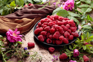 Summer still life with, raspberries, flowers and meadow grasses.