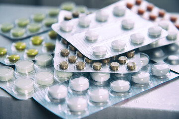 Overall view of pharmaceutical tablets and capsules in packages in assortment
