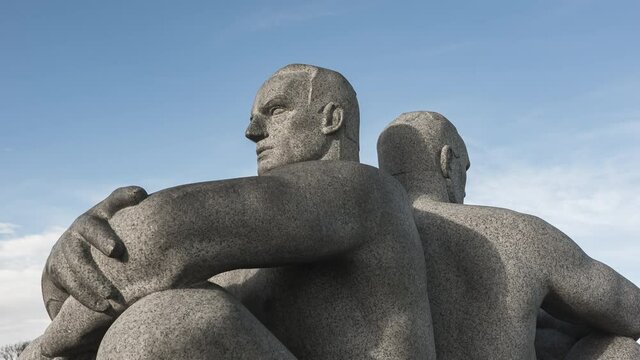 Granite Sculpture Of Two Men Sitting Back to Back With Crossed Arms At Vigeland Installation In Frognerparken, Oslo, Norway. -  hyperlapse
