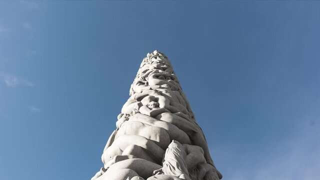 Monolith Against Blue Sky At Frogner Park. Vigeland Sculpture Park In Oslo, Norway. low angle, time lapse