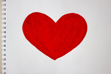 Fototapeta premium Heart drawing with red colors on a white album sheet. Close up photo