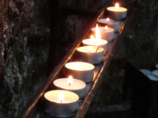burning candles in a church close up