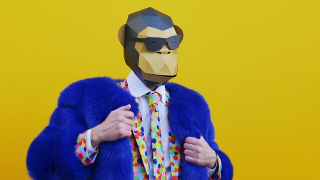Man wearing funny masks and doing party. Celebrating and dancing over colored backgrounds