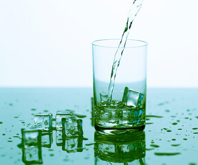 clear water spray in a glass with ice, clear water in a glass with spray