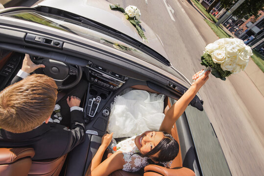 a happy bride and groom are driving their car into the future