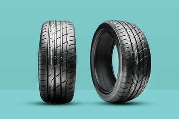 two new summer tires on a green background - obrazy, fototapety, plakaty
