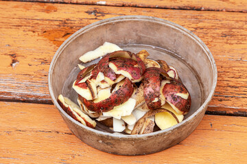 Heap of potato peels in a plastic bowl
