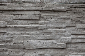 Stone gray background consisting of small gray bricks. Wall decor