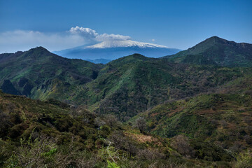 Fototapeta premium pastures and valleys under the Etna volcano in Siiclia still smoking