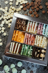 Multi-colored chocolate. Assortment of chocolates, white, dark and milk chocolate Sweets background. Copy space.