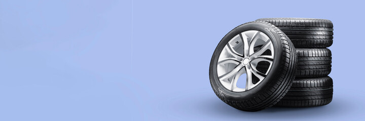 summer tires and wheels-stack on blue background, new wheels long blank layout copyspace