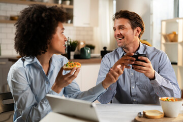 Loving couple drinking coffee and eating sandwich. Happy smiling wife enjoy in the morning with her husband..