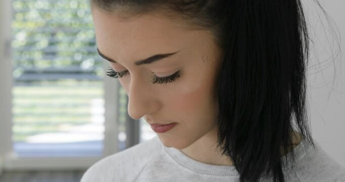 3 takes in one clip of neutral, stern and cheering of a girl with smartphone