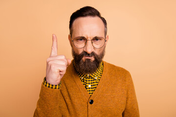 Photo of aggressive strict man frown raise finger wear eyewear brown cardigan isolated beige color background