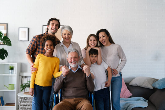 Extended Happy Family Generations Portrait At Home With Handicapped Senior