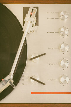 Vertical close up of a vintage seventies turntable with spinning record