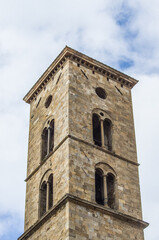 ancient bell tower with bells and flag of the historic city