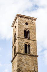 Fototapeta na wymiar ancient bell tower with bells and flag of the historic city