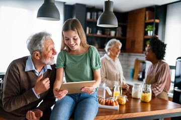 Multiethnic three generation family in kitchen with senior grandparents